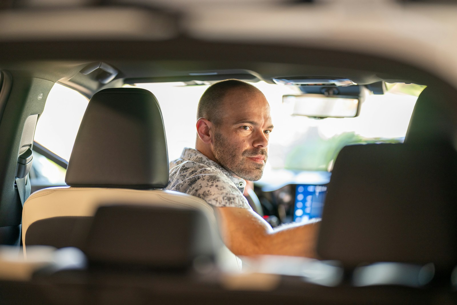 a man sitting in the passenger seat of a car